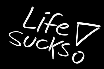 Life sucks symbol on blackboard