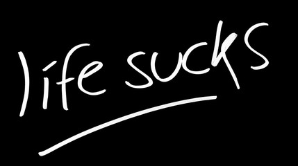 Life sucks symbol on blackboard