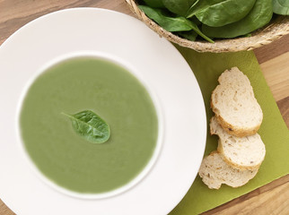Vegetable spinach soup and ingredients on wooden table. Top view.