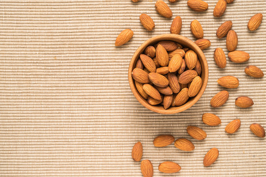 Almonds In Brown Bowl On Place Mat Background, Top View