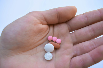 A pile of pills in her hand