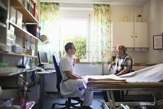 Doctor talking to patient in office at hospital