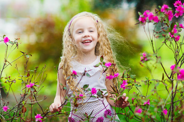 Beautiful girl and pink flowers in the garden
