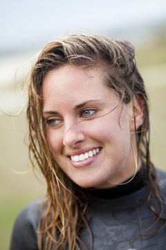 Close-up of happy wet woman at beach