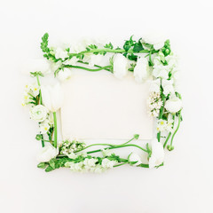 Floral frame of white ranunculus, snapdragon, lilac and tulip on white background. Flat lay, top view.