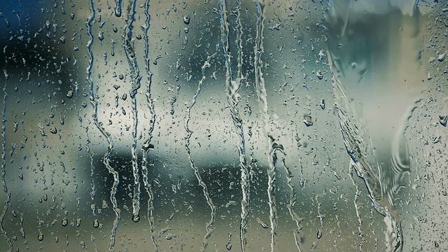Abstract Drops of Summer Rain Stick on the Glass