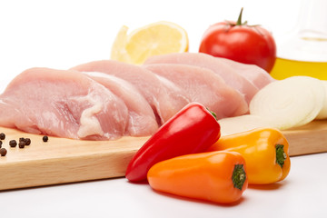 Raw turkey meat fillet and vegetables.