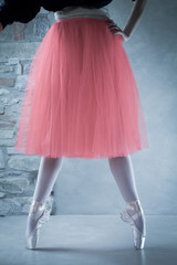 ballet dancer on pointes in second position with beautiful pink tutu
