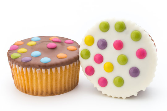 Multiple colorful decorated muffins on a white background.