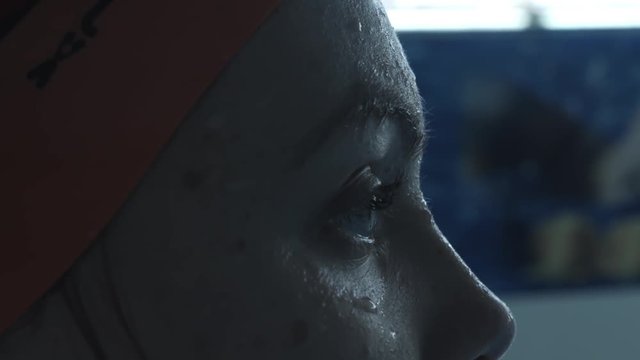 Girl swimmer looks into the pool before jumping. Close-up