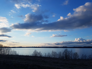 Obraz premium Spring landscape with field and pond.