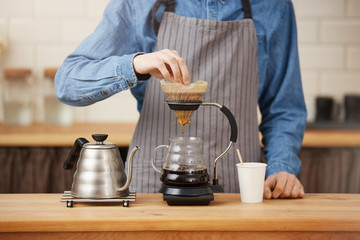 Closeup of rofessional bartender preparing pourover coffee