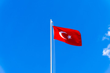 turkish flag waving in blue sky