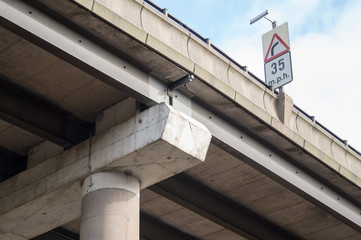 35 mph road sign on motorway overpass