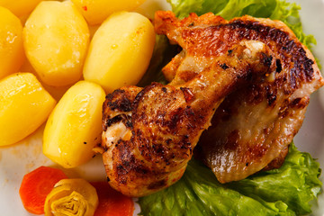 Roast chicken leg with potatoes