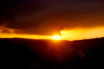 sunset landscape small mountain with clouds in the sky red