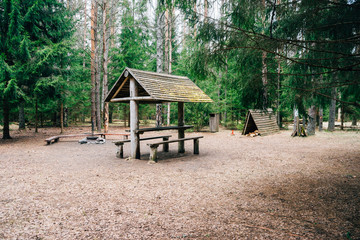 Camping place with wooden table and fireplace