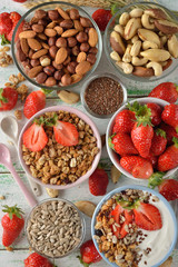 Muesli, nuts, yogurt and cereals on a white background