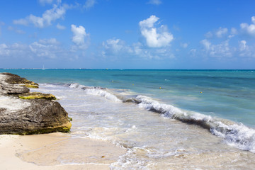 Shores of the Caribbean sea. Waves hitting the shore on a sunny day.
