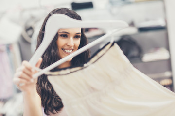 Smiling Woman Buying a Dress