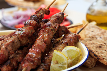 Grilled meat skewers in a dish