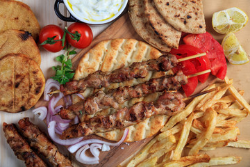 Grilled meat skewers on a pita bread - top view