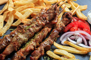 Grilled meat skewers and side dish