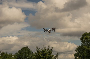 Fototapeta na wymiar Quadcopter drone flying above trees