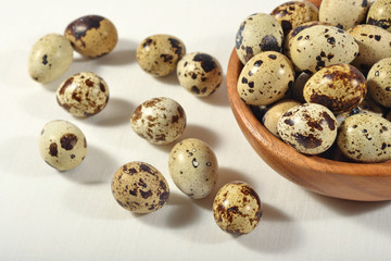 Fototapeta premium Quail eggs in a wooden bowl in a sacking