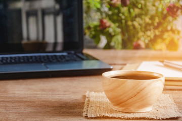 coffee cup and notebook on wood table