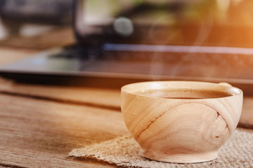 coffee cup and notebook on wood table