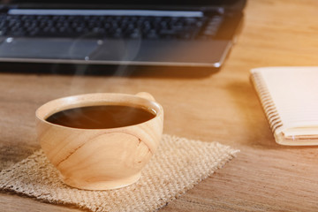 coffee cup and notebook on wood table