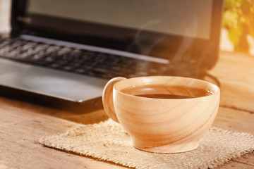 coffee cup and notebook on wood table