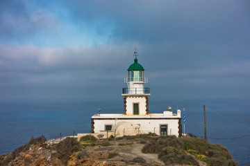 Fototapeta na wymiar Akrotiri lighthouse at sunny morning with picturesque clouds, Santorini island, Greece