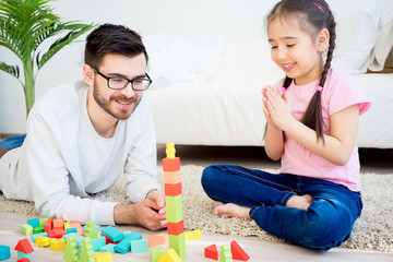 Family playing with toy blocks