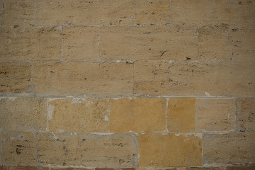 Texture of a smooth stone wall sand color
