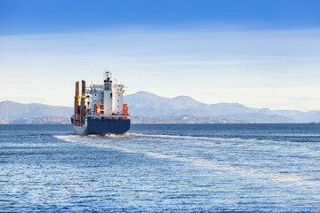 Container ship goes on Norwegian sea, rear view