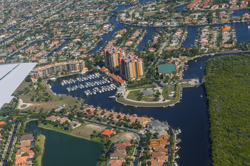 Fototapeta premium Aerial view of city and gulf Cape Coral, Florida. The Westin Cape Coral Resort at Marina Village