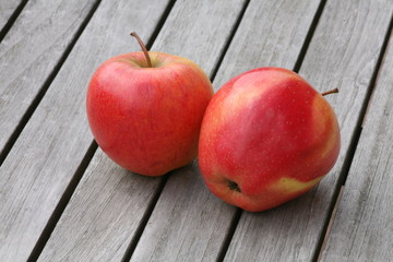 two apples on wooden table