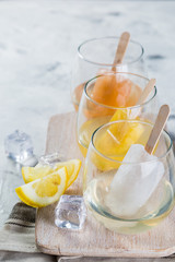 Colorful ice popsicles with wine in glasses