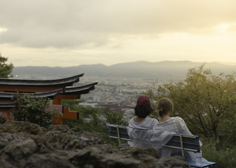 A couple watching a warm panorama from the Fushimi Inari-taisha