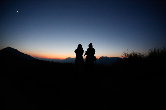 young couple  silhouette  hill