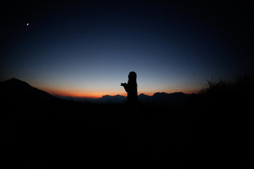 sunset silhouette, young lady in hill