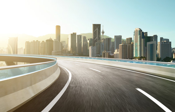 Highway overpass modern city skyline background . Sunrise scene .