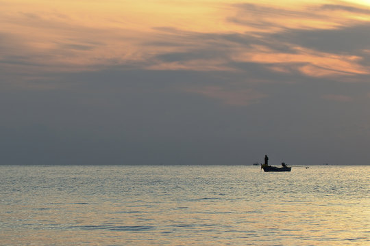 silhouette of traditional fishing boat with Golden sunrise light