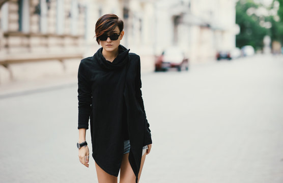 Beautiful young woman model walking and posing on the street