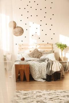 Bed in trendy bedroom