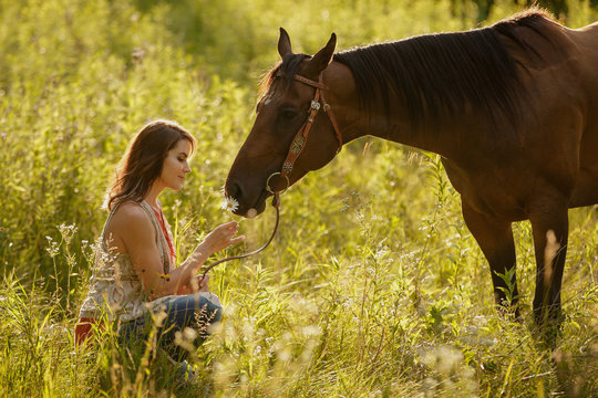Woman with her horse in field