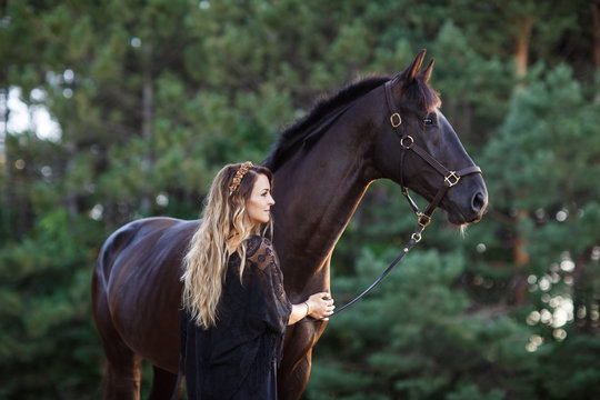 Woman standing with a horse