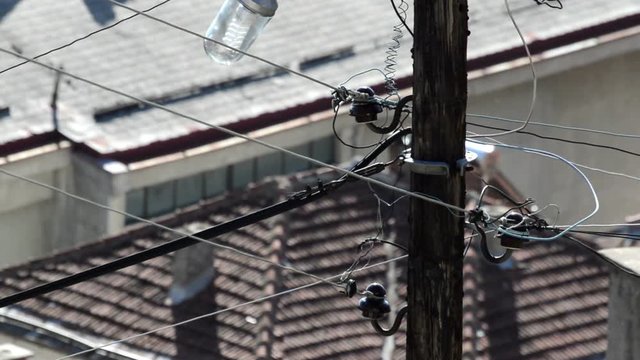 Wooden electric pillar with wires & lamp.